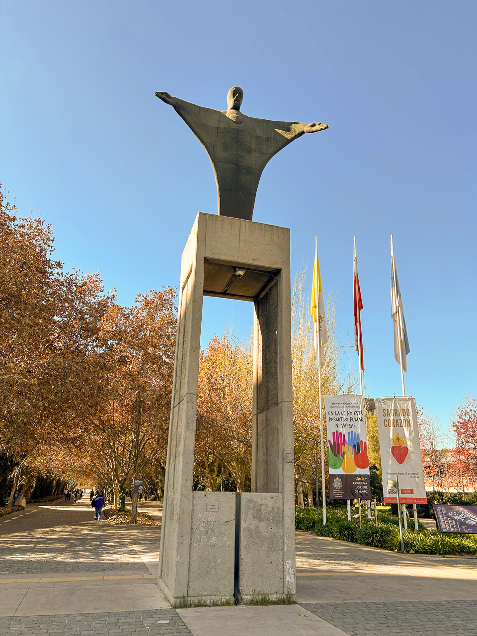 photograph: a concrete monument, trees, flagpoles