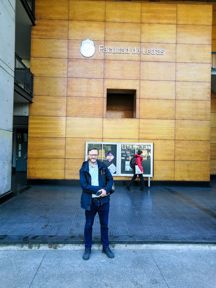 photograph: a person poses in front of a building