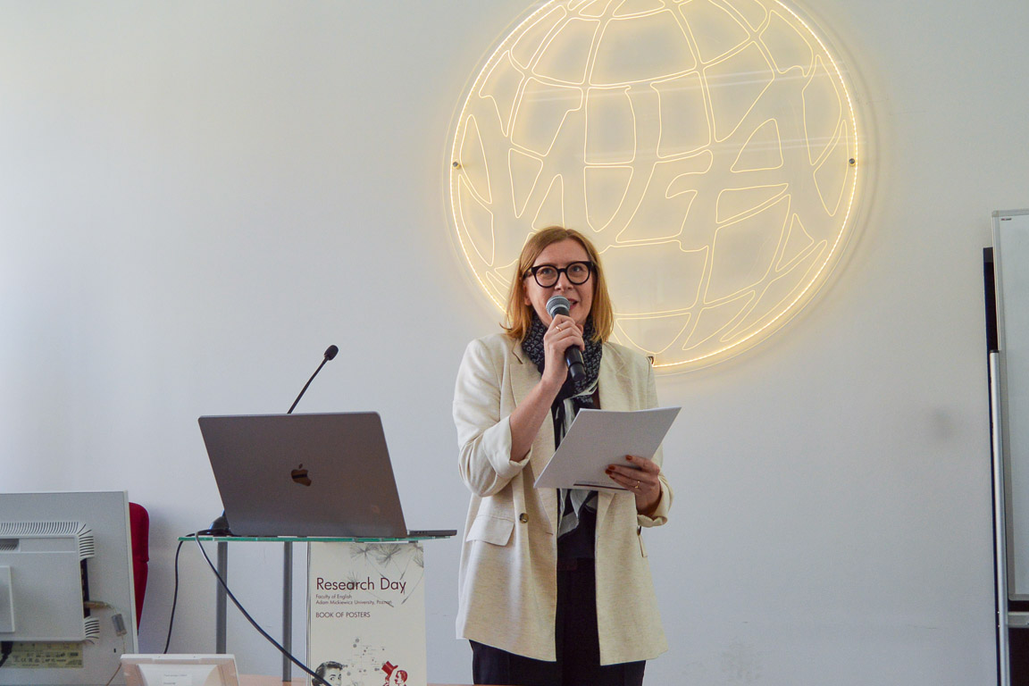 photograph: person with a microphone in hand addresses the audience (who are out of frame)