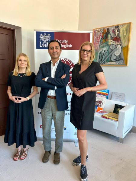 photograph: three persons pose for a photograph in an office