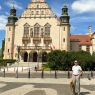 zdjęcie: osoba pozuje do zdjęcia przed gmachem