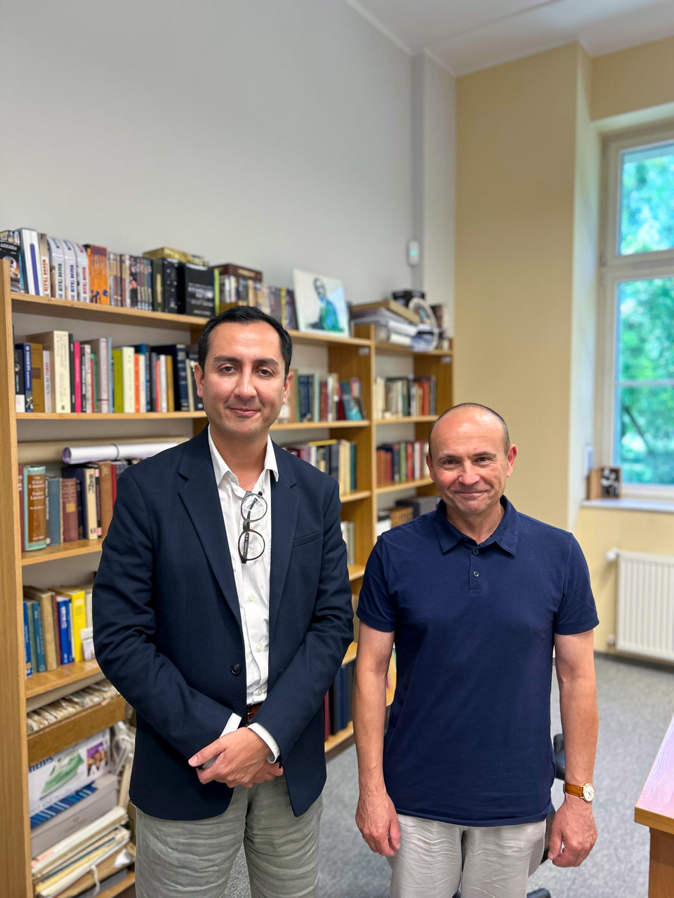photograph: two persons pose for a photograph in an office