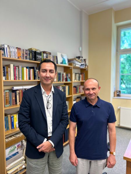 photograph: two persons pose for a photograph in an office