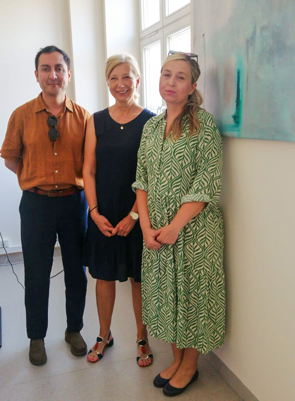 photograph: three persons pose for a photograph