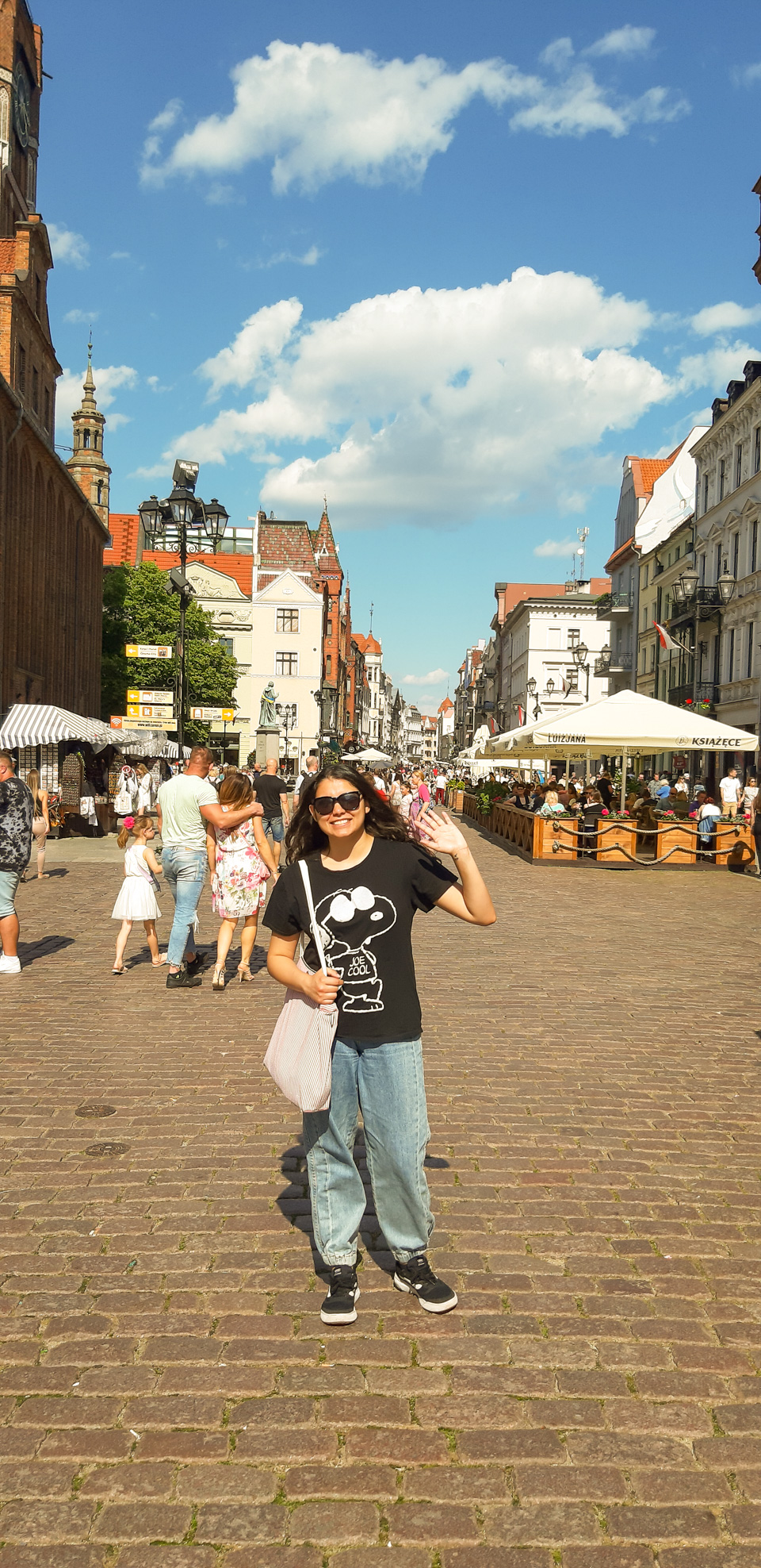 photograph: a person poses for a photograph at the Medieval Town in Toruń
