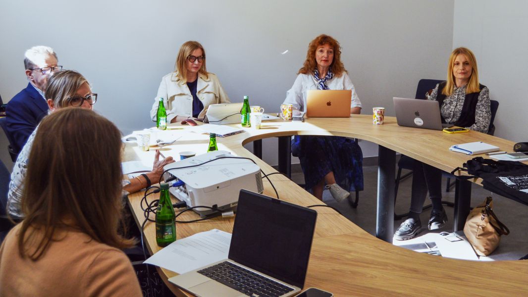 photograph: a group of six people sitting by a conference table