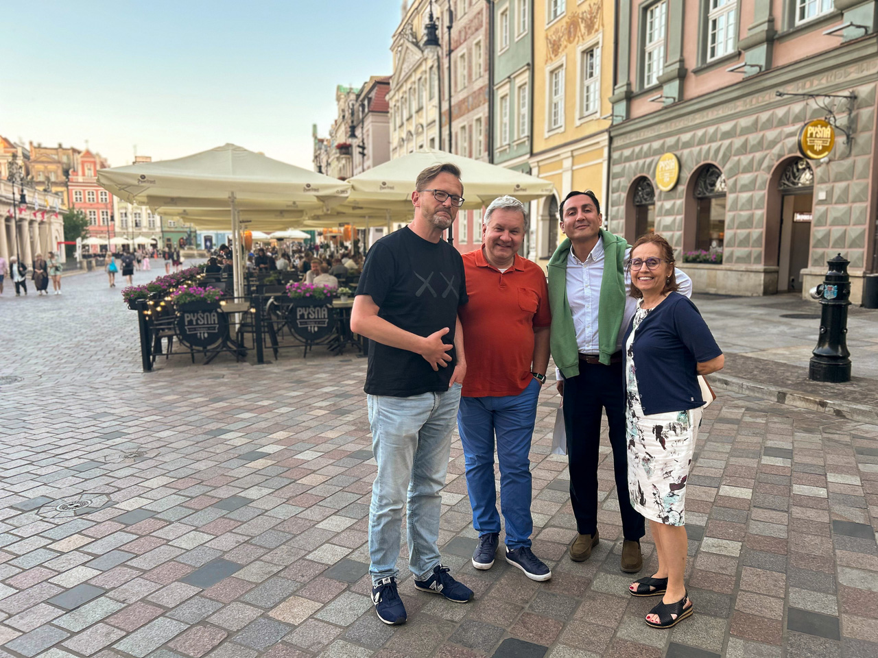 photograph: four persons at the Old Market Square in Poznań