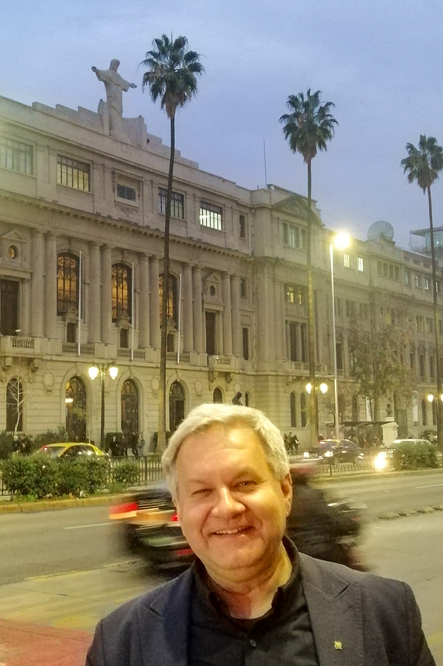 photograph: a person poses for a photograph in front of a building