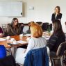 photograph: a group of people sit by a table in a seminar room
