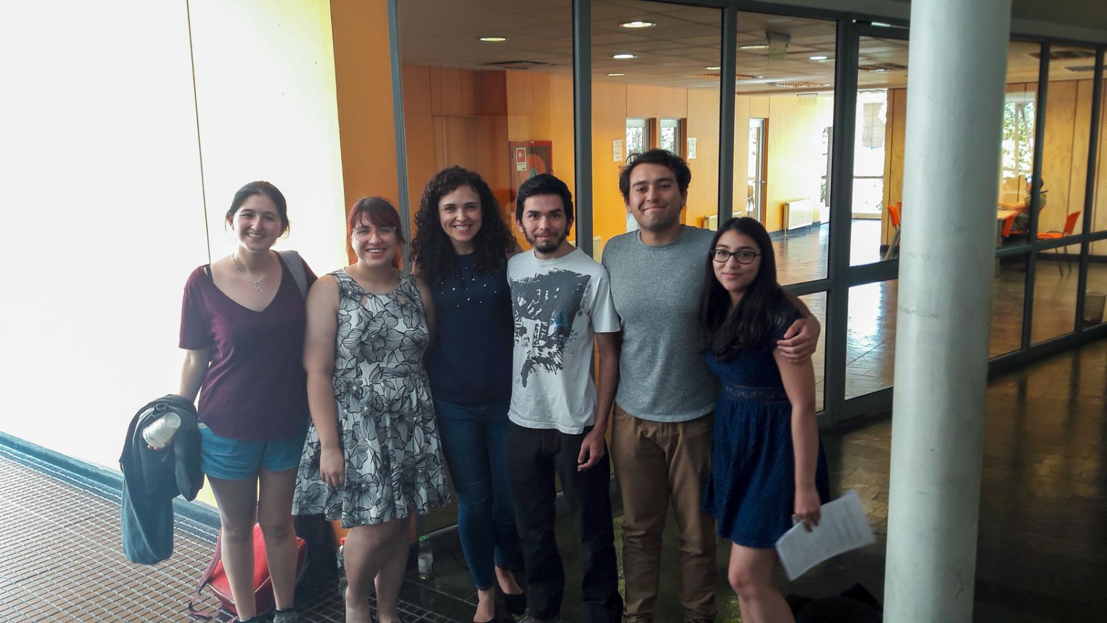 photograph: six persons pose for a photograph