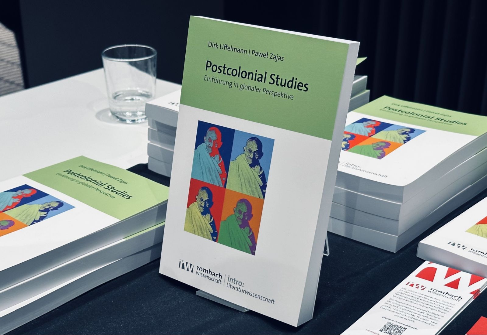 zdjęcie: stos egzemplarzy książki „Postcolonial Studies” wyeksponowany na stole podczas wydarzenia