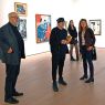 photograph: four people touring an exhibition room in a museum/gallery