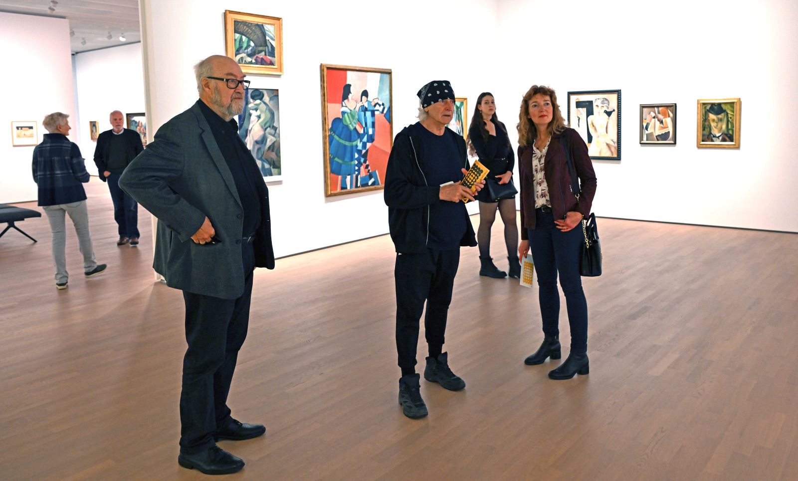 photograph: four people touring an exhibition room in a museum/gallery