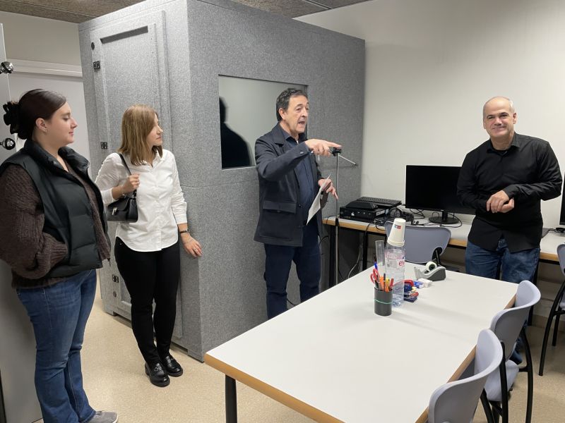 photograph: a group of four people standing in a laboratory