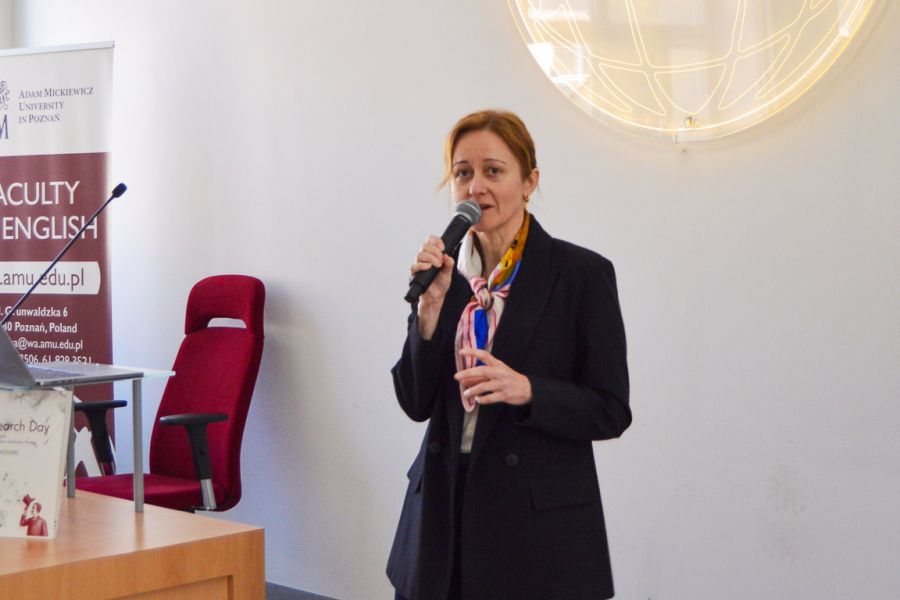 photograph: person with a microphone in hand addresses the audience (who are out of frame)