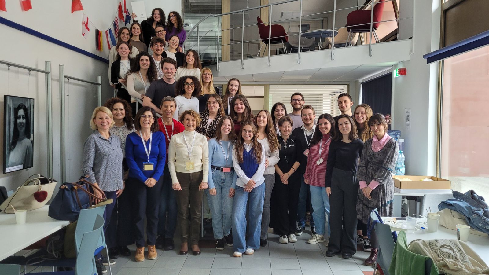 photograph: group of more than ten people pose in a seminar room