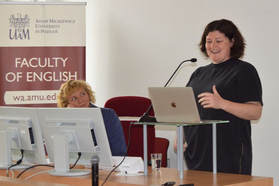 photograph: a person addresses the audience from behind the pulpit; another person looks at the speaker