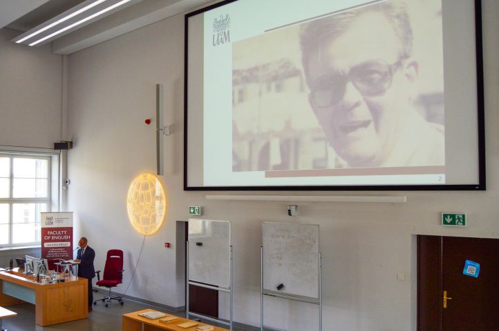 photograph: screen on which a slide is being displayed: photograph of Prof. Zbierski