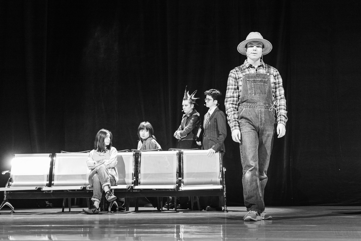 photograph: five people on a stage in a theatre during a rehearsal