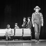 photograph: five people on a stage in a theatre during a rehearsal