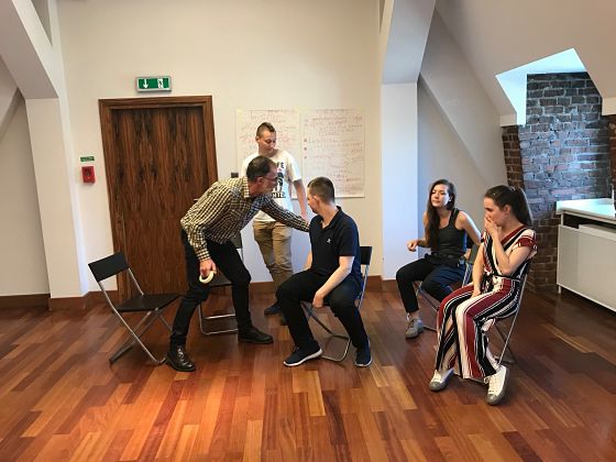 photograph: a group of five people during an acting class